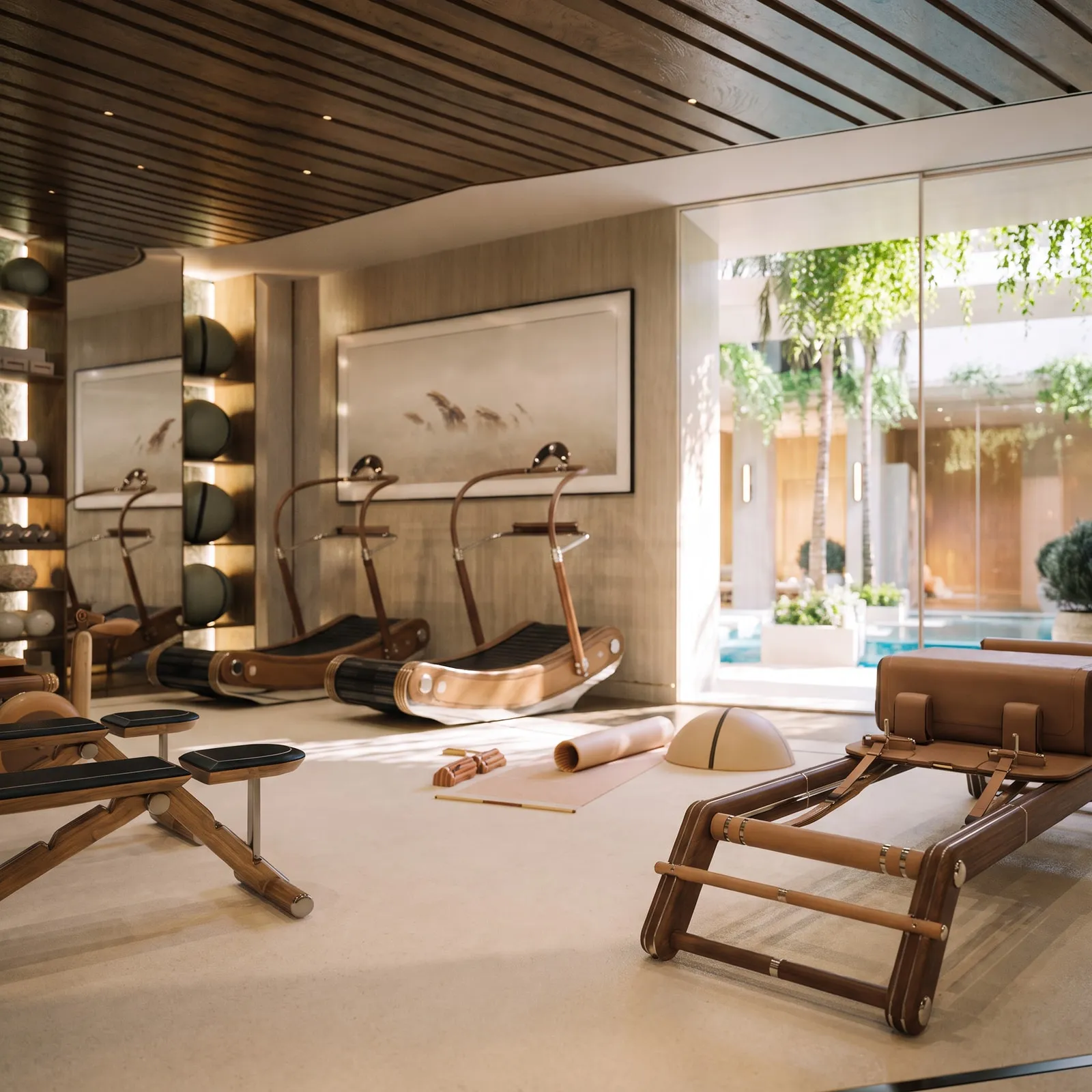 The wellness retreat’s rowing machines and reformer, the courtyard beyond the glass